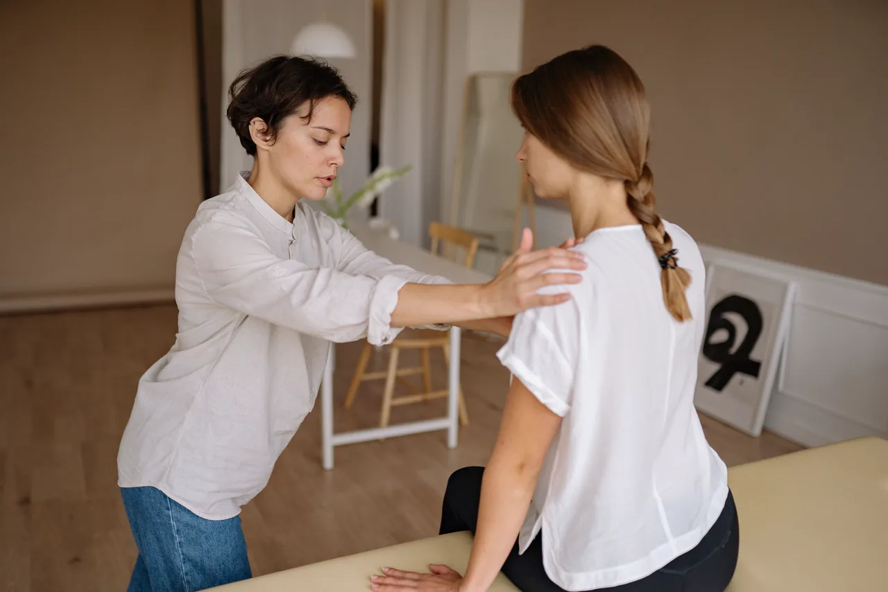 A therapist treating a patient's shoulder