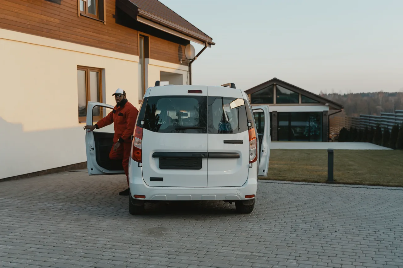 A technician stepping out of his van at a customer's home